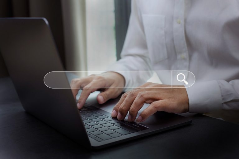 image with a business man in front of his laptop looking for an airport transfer quote